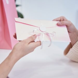 Aesthetic clinic employee presenting discount voucher to client