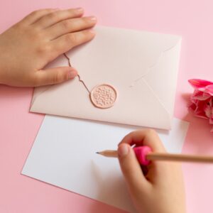 Top view of child,writing on blank certificate gift.